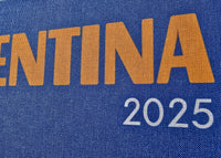 Blue sign with 'ARGENTINA 2025' text on a fabric background