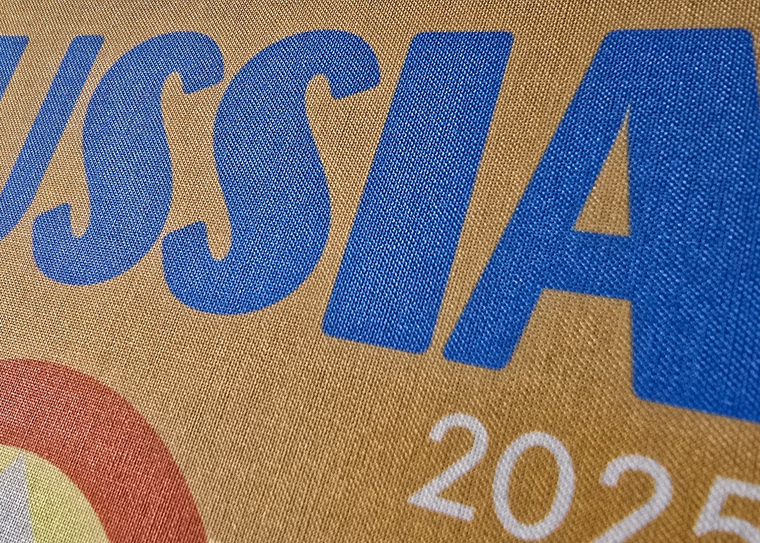 Text 'RUSSIA 2025' printed on a textured surface with a brown background.