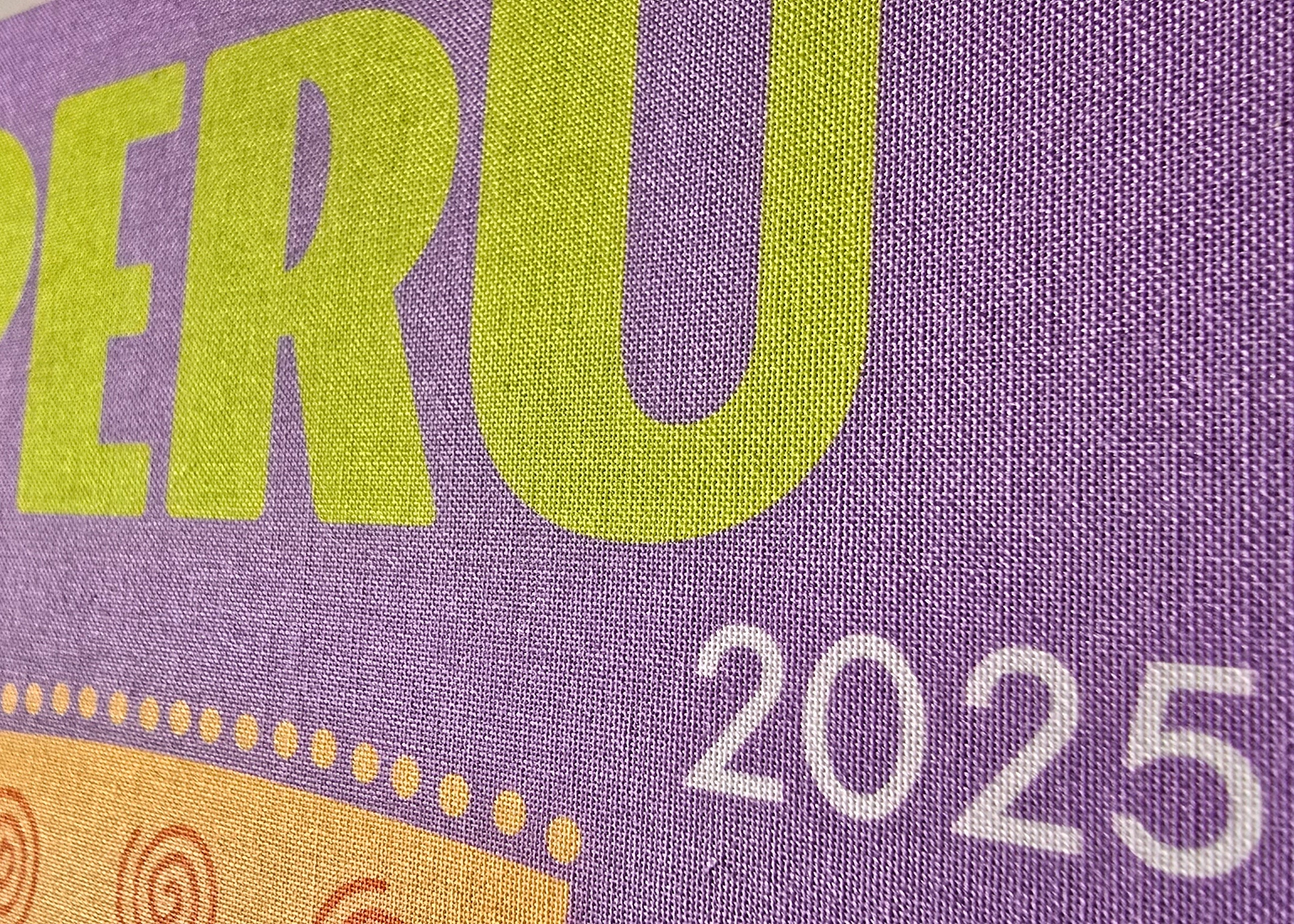 Purple book or notebook with 'PERU 2025' text on a purple background