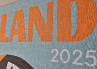 Textile item with 'ICELAND 2025' printed on it, featuring a stylized map design.