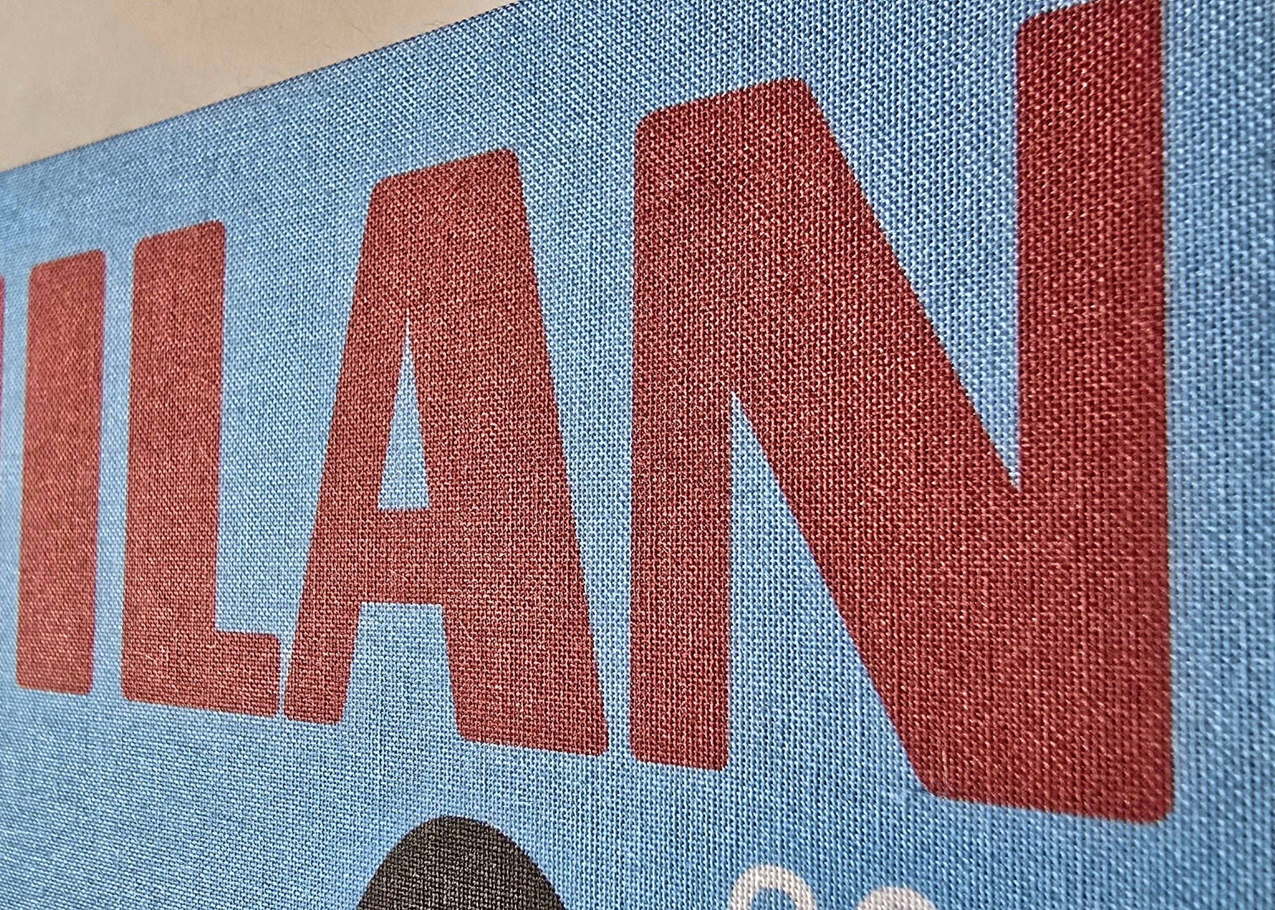 Text 'MILAN' printed on a blue background