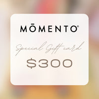 Momento $300 gift card on a blurred background