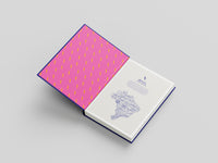 Notebook with pink patterned cover and white interior on a gray background
