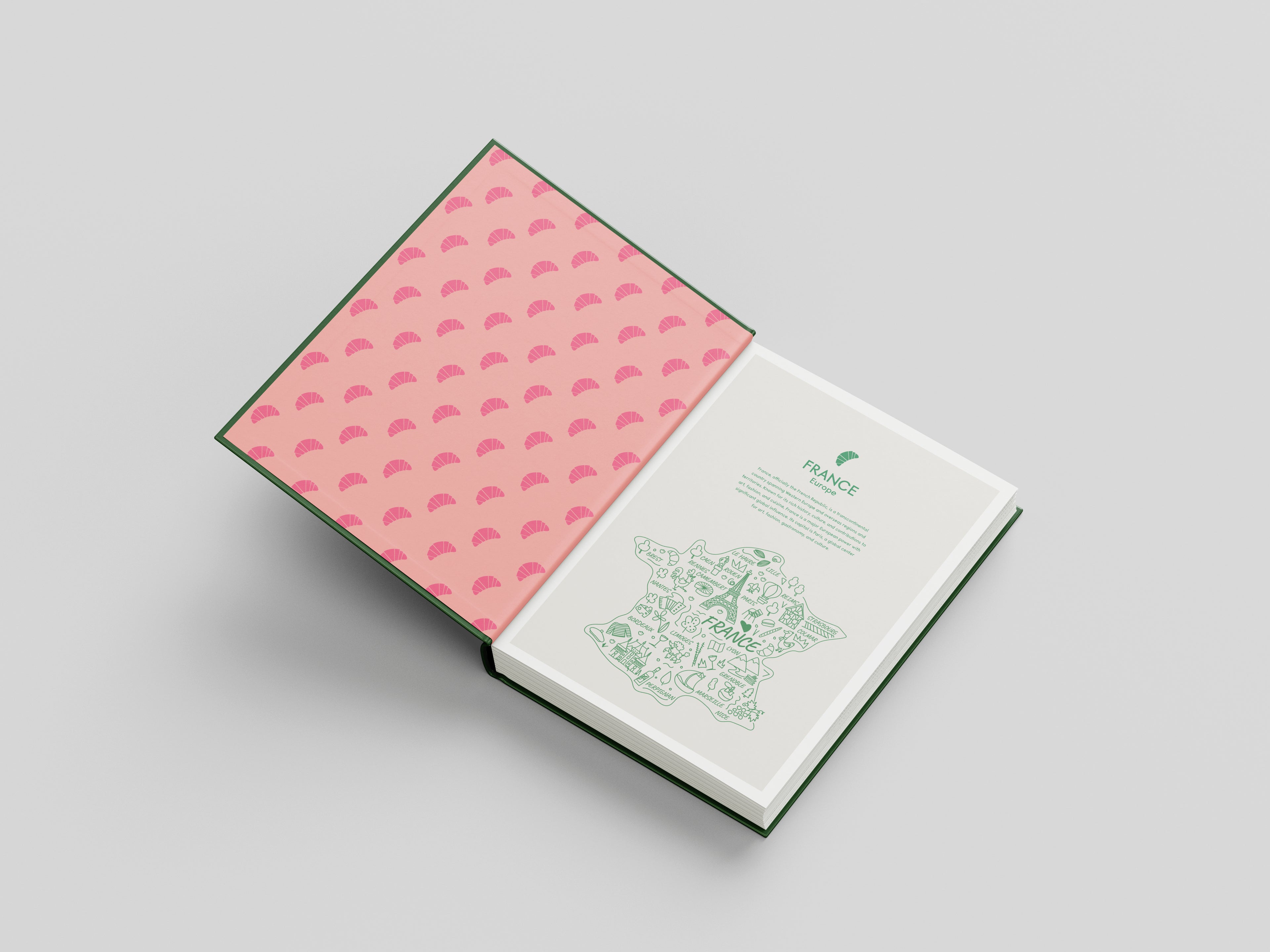 Notebook with pink patterned cover and green text on a light gray background