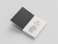 Open notebook with a black cover and white pages on a light gray background
