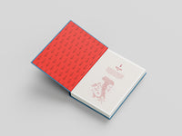 Open book with red interior pages on a gray background
