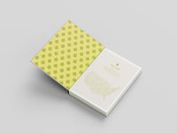 Notebook with green polka dot cover and white interior on a light gray background