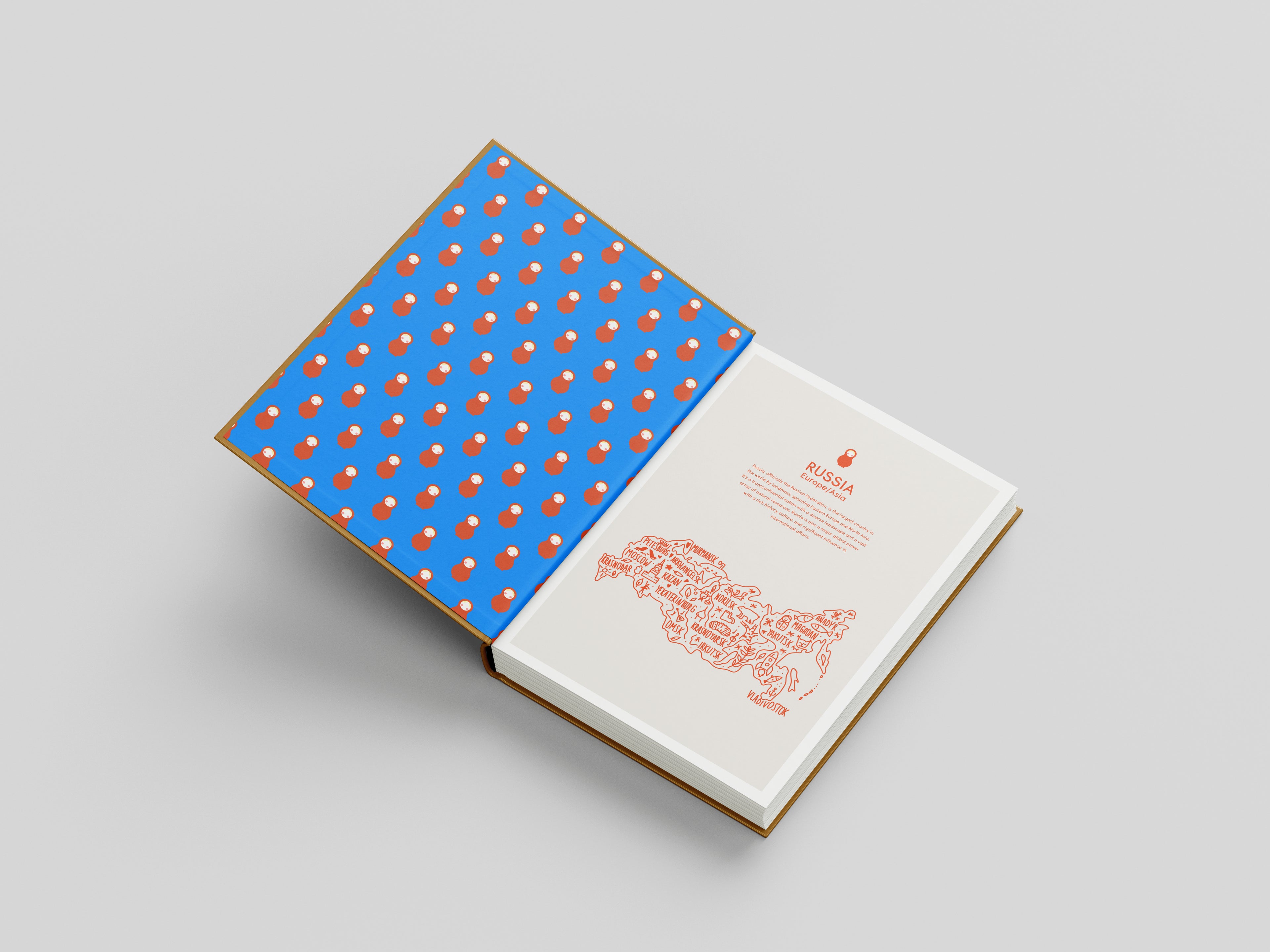 Book with blue cover featuring orange pattern and white pages on gray background