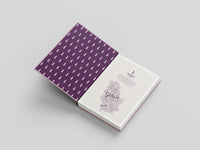 Open book with purple patterned cover on a light gray background