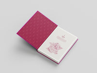 Open book with pink and white cover on a light gray background