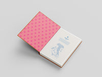 Pink notebook with heart pattern on a gray background
